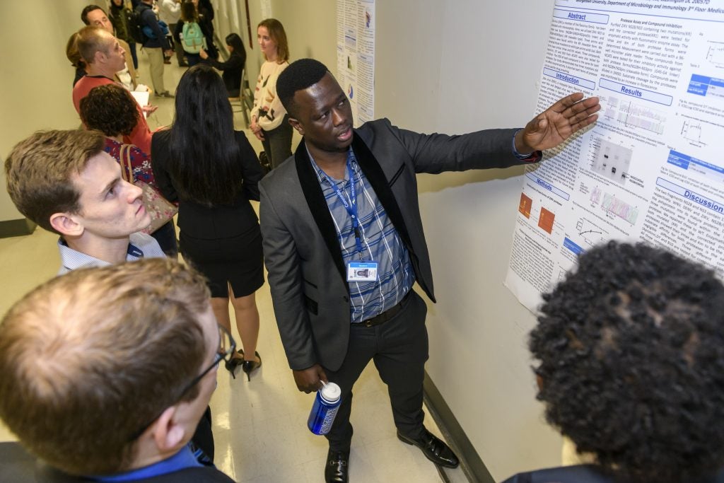 A student points to the findings of a research project.