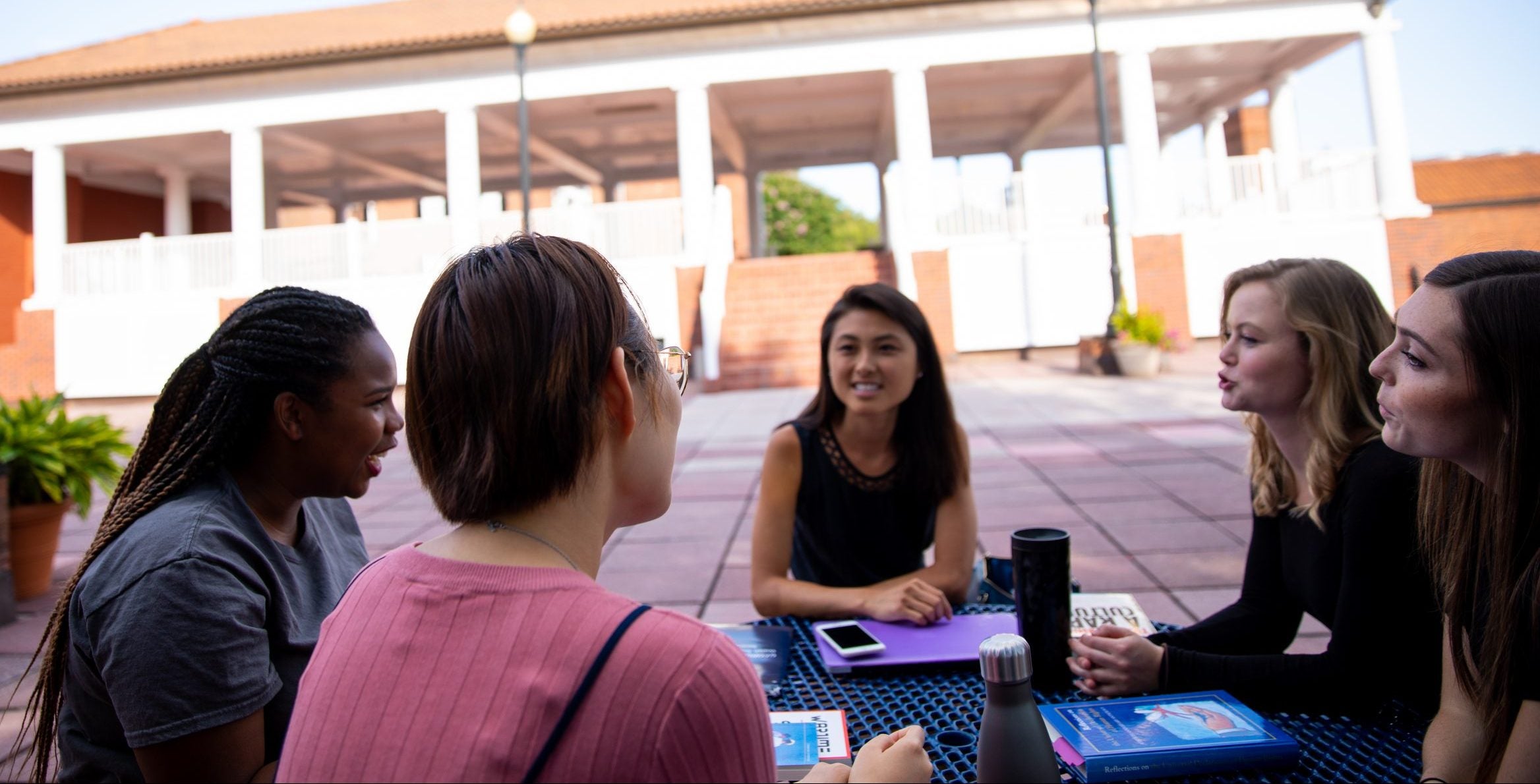 Students sit in a circle for a glass discussion