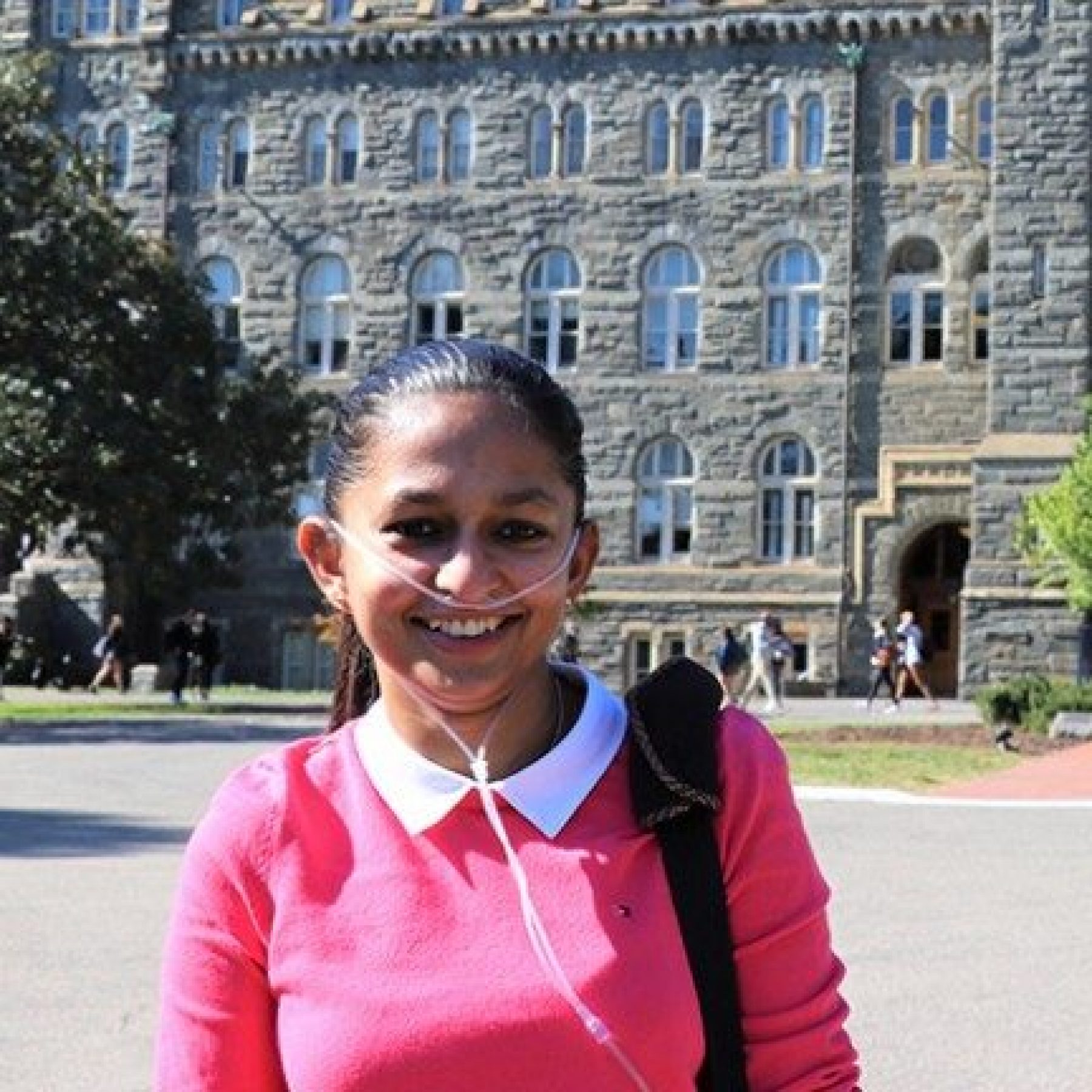 A portrait of Shavini standing in front of Healy Hall.