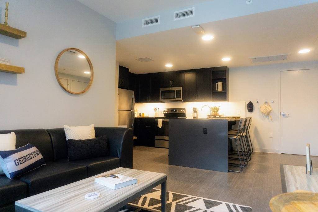 Living room showcase looking into the kitchen for a Georgetown apartment at 55 H Street