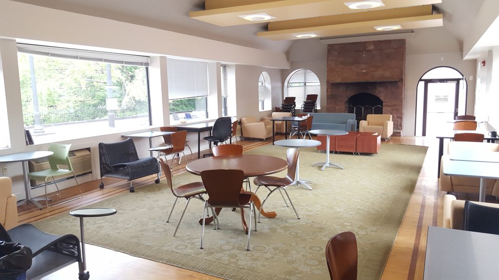 Panoramic view of the Graduate Student Quiet Study Lounge in Car Barn building with tables, chairs and window space