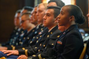 ROTC students sit in uniform inside Gaston Hall