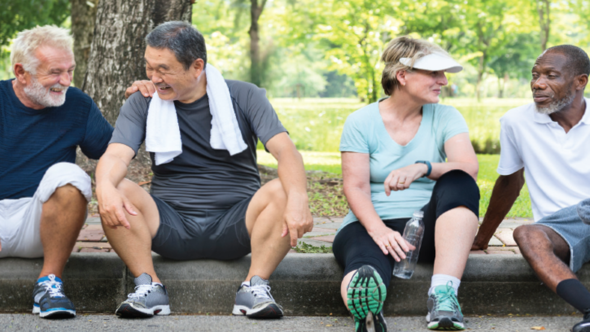 Four aging mid-life Americans sit on curb in their workout clothes