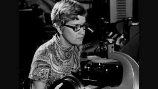 A young Vera Rubin (G&#039;54) peers into a microscope at the Carnegie Institution