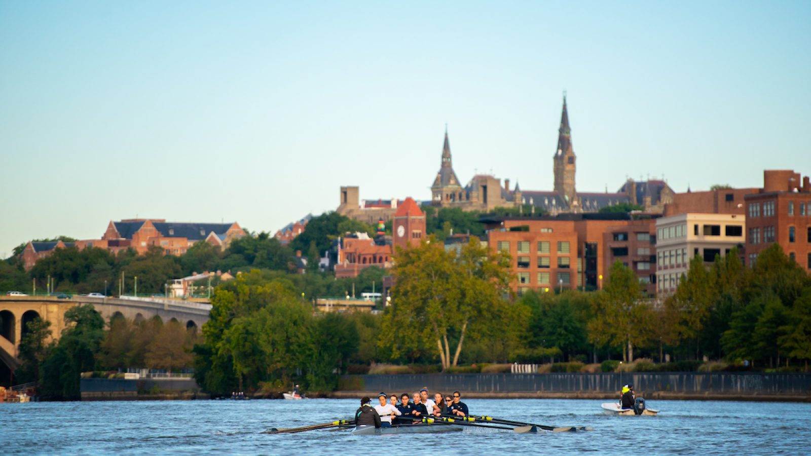 View of the Potomac River with crew boat on the water and skyline of Georgetown University