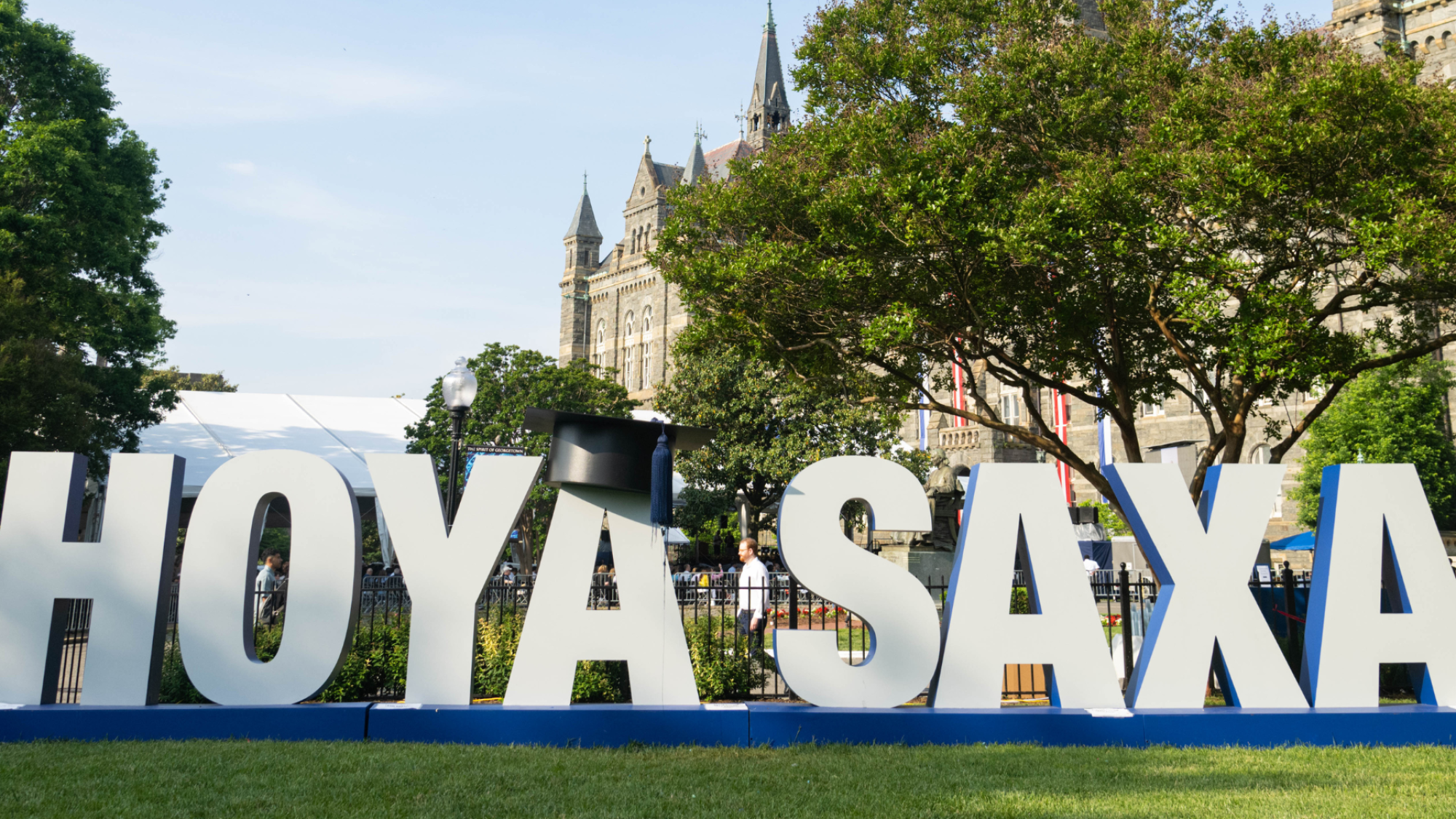 Hoya Saxa sign on in front of Healy Hall at graduation in spring