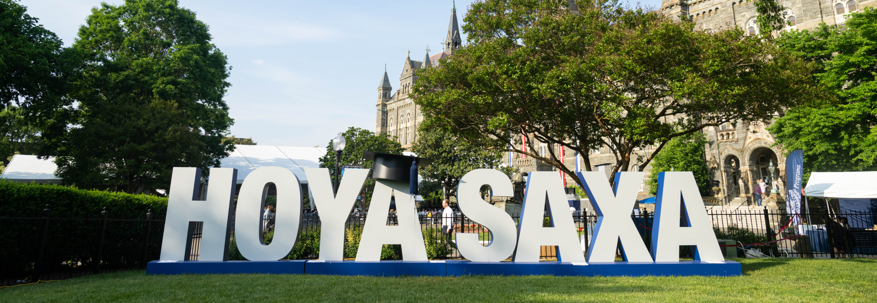 Hoya Saxa sign on in front of Healy Hall at graduation in spring