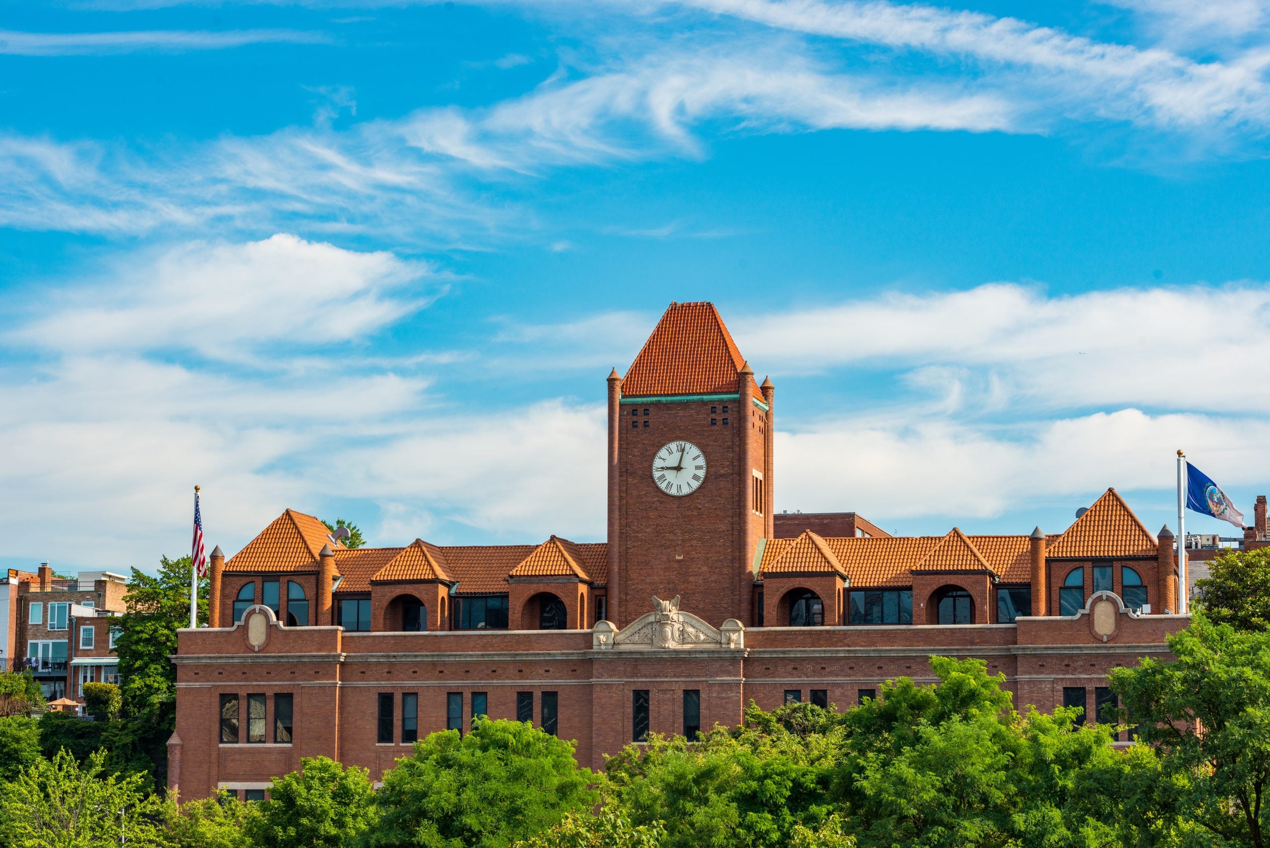 Car Barn building at Georgetown University with a cloudy blue sky and green trees