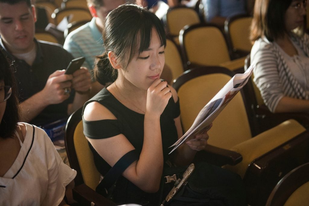 Woman reading while sitting down.