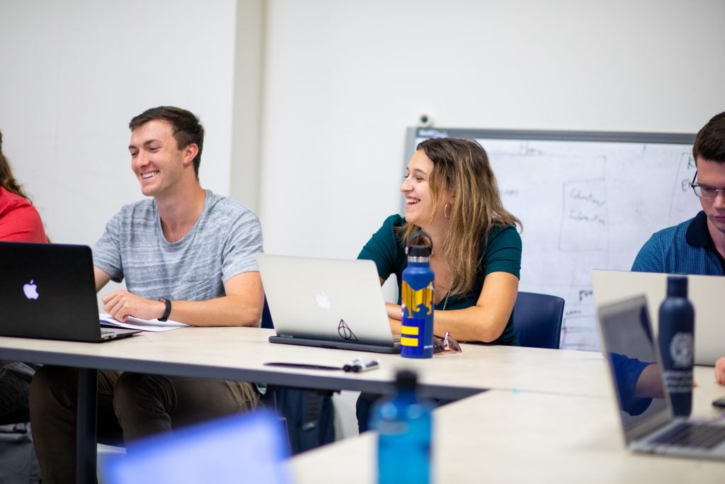 Students smiling while in class at Georgetown University