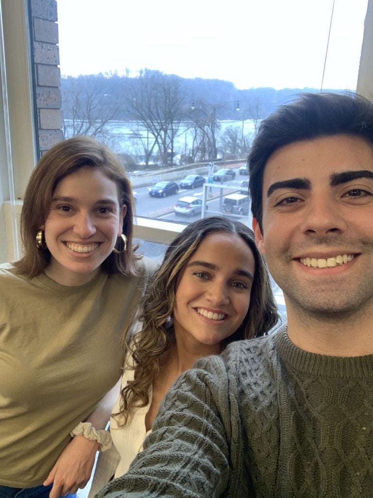 Lucia Szyman Mulero, Carolina Alvarado, Ricardo Pereira Teixeira smile as they take a selfie inside the 3rd floor study lounge inside Car Barn