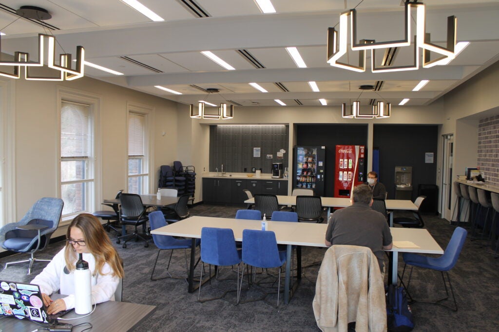 Students sit at tables in a graduate lounge inside Car Barn building at Georgetown