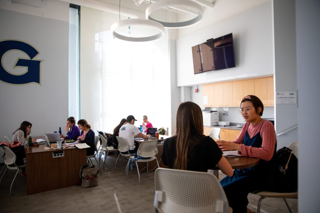 Students sitting down in a room together.