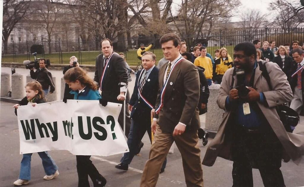 Ken Rutherford (center) walks during 1998 landmine survivor demonstration at the White House