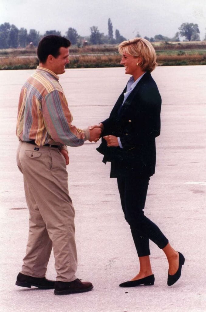 Princess Diana (right) shakes hands with Ken Rutherford (left) in Sarajevo on August 8, 1997