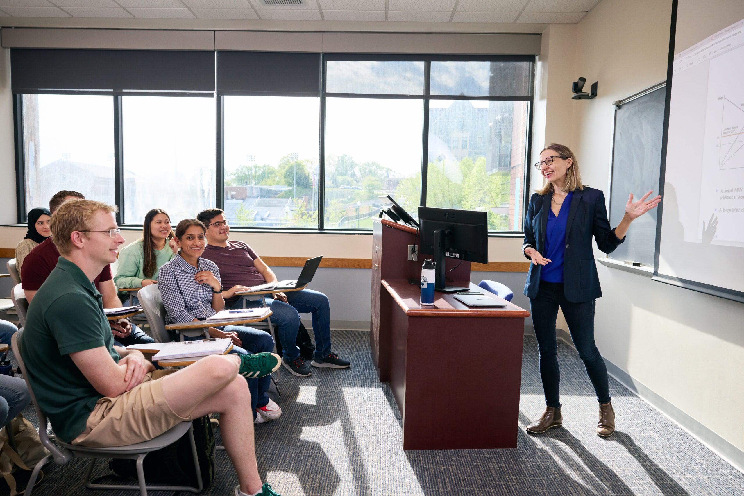 Students sitting at desks in a classroom at Georgetown University engage with a faculty member at the front of the room