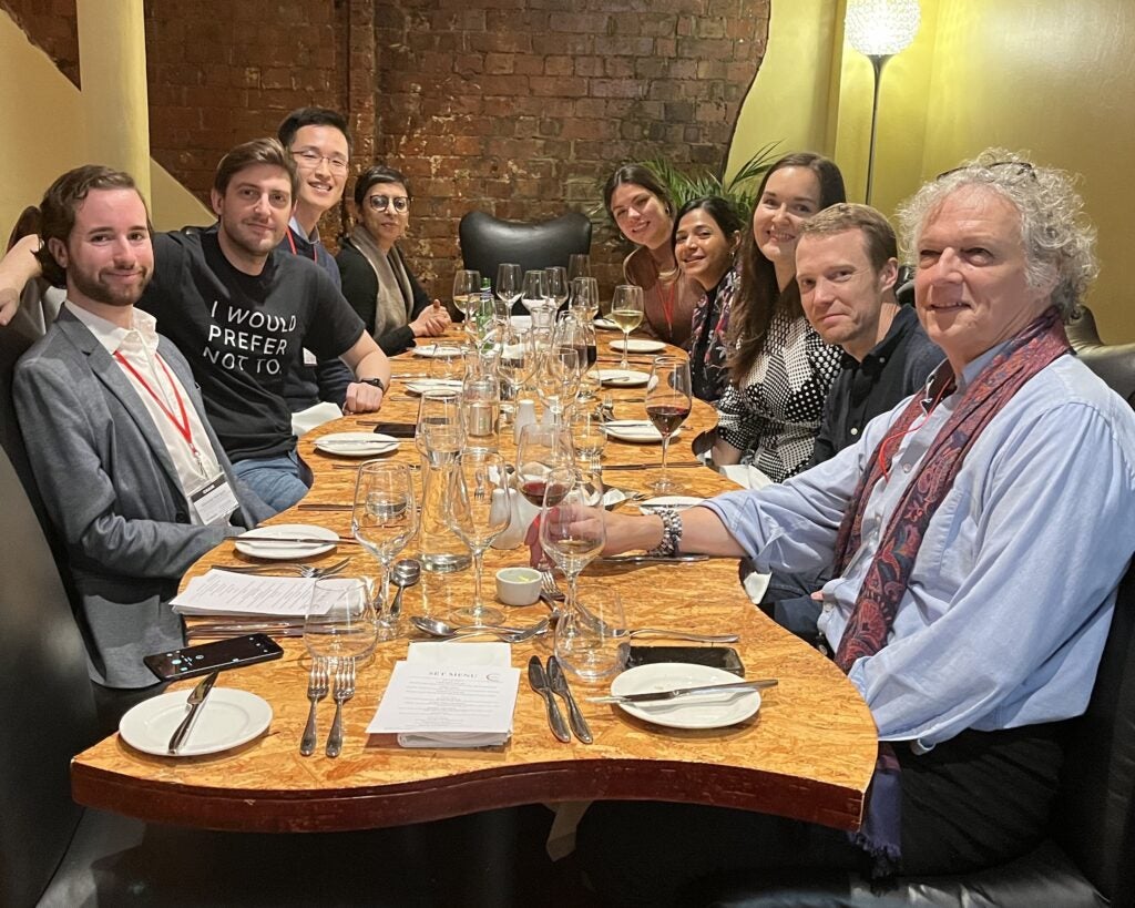 Rodriguez (front left) sits at a dinner table with colleagues from the Millennium Journal in the UK (November 2023)