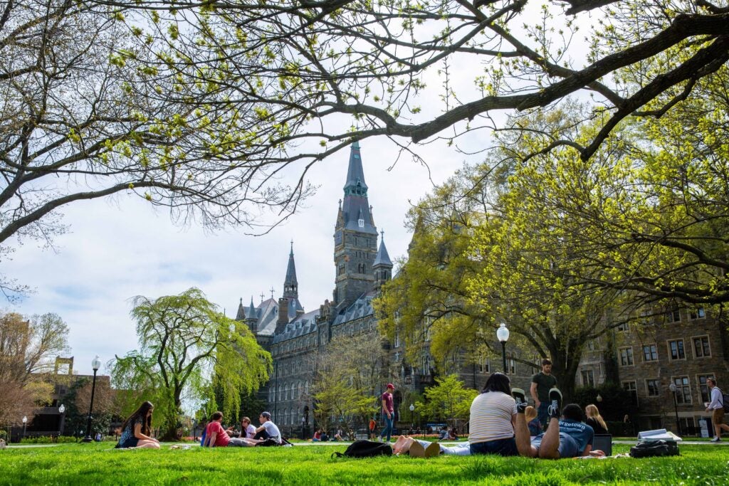 Students lying on the lawn in front of Georgetown Campus