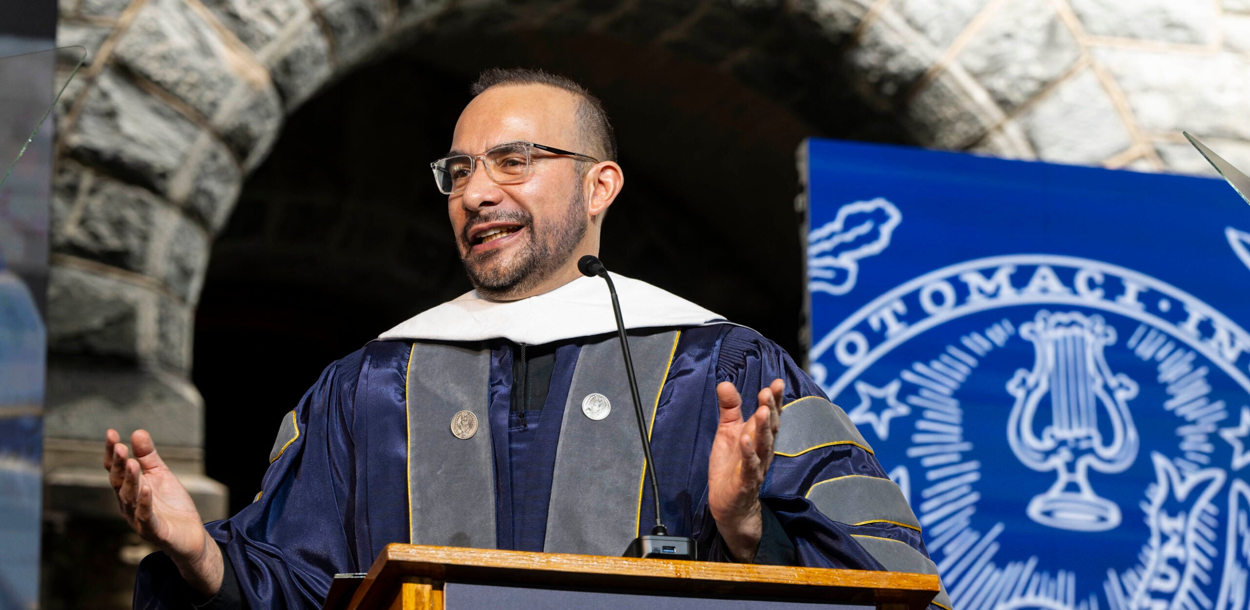 Father Luis Arriaga Valenzuela addresses the crowd from a podium at commencement for Georgetown's Graduate School of Arts and Sciences.