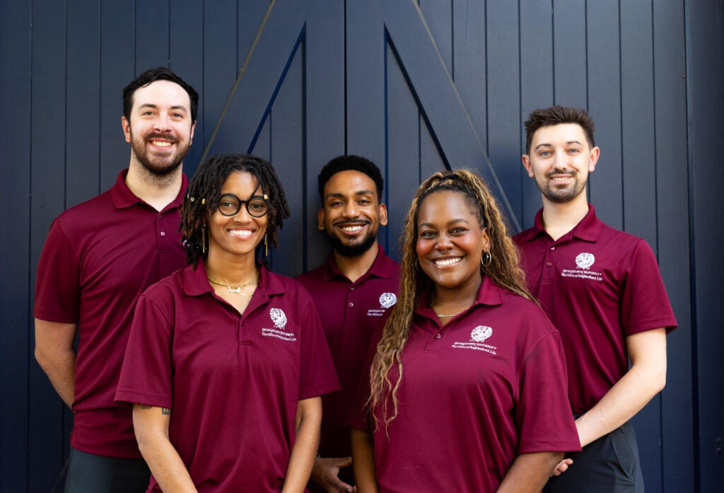 Five members of Georgetown's Office of Neighborhood Life pose for a group photo.