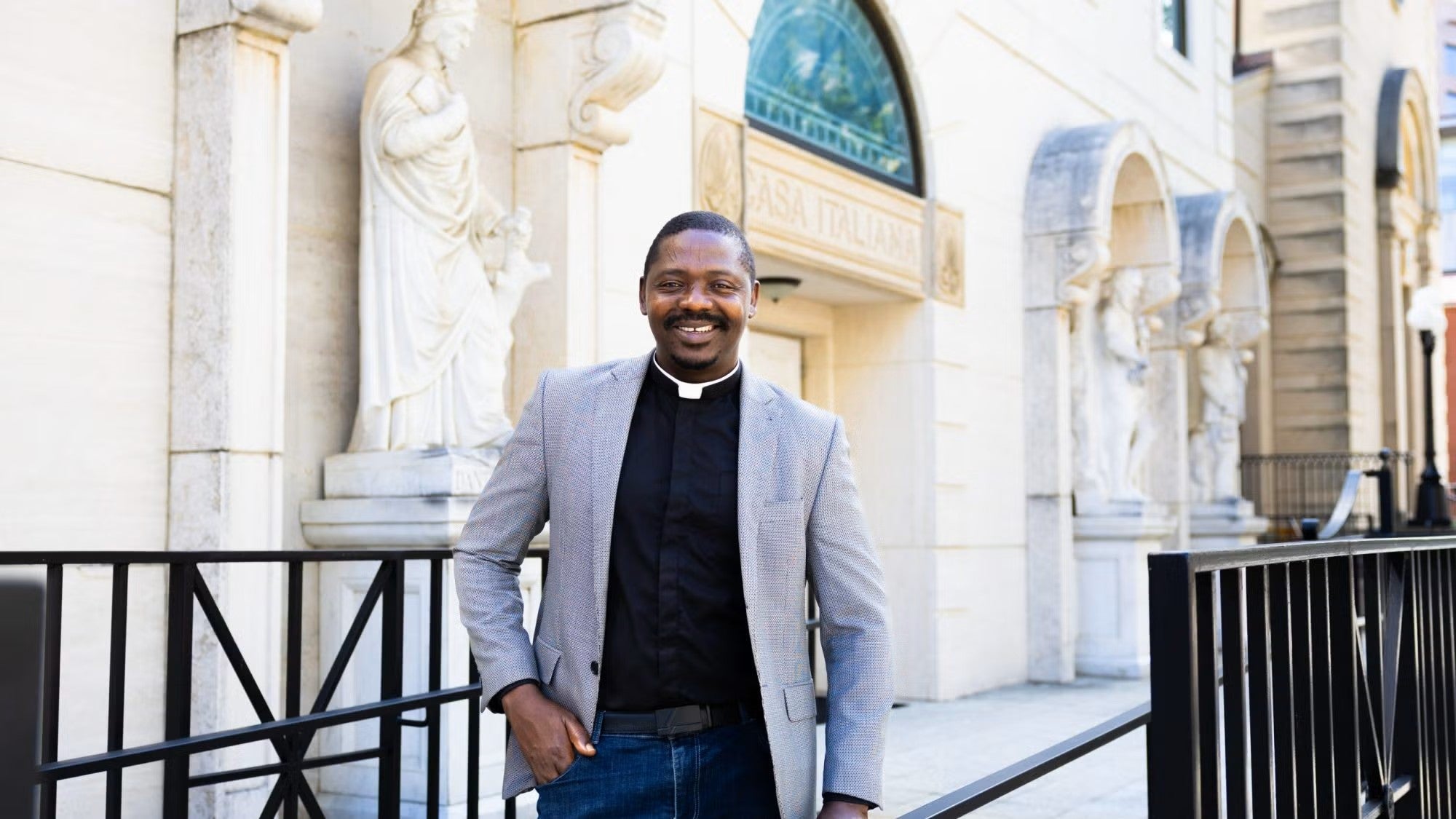 Fr. Taroh Amédé smiles outside a church near Georgetown's Capitol Campus.