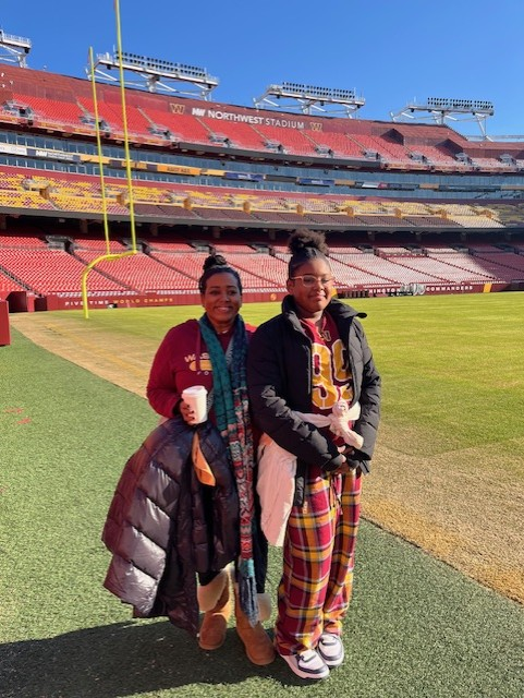 Hazlewood at a Commanders game with her daughter.