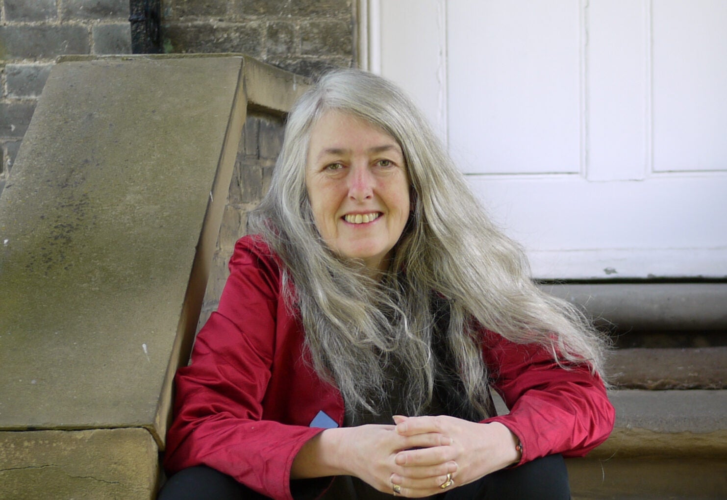 A cropped author photo of Mary Beard, a woman with long gray hair, taken by Robin Cormack.