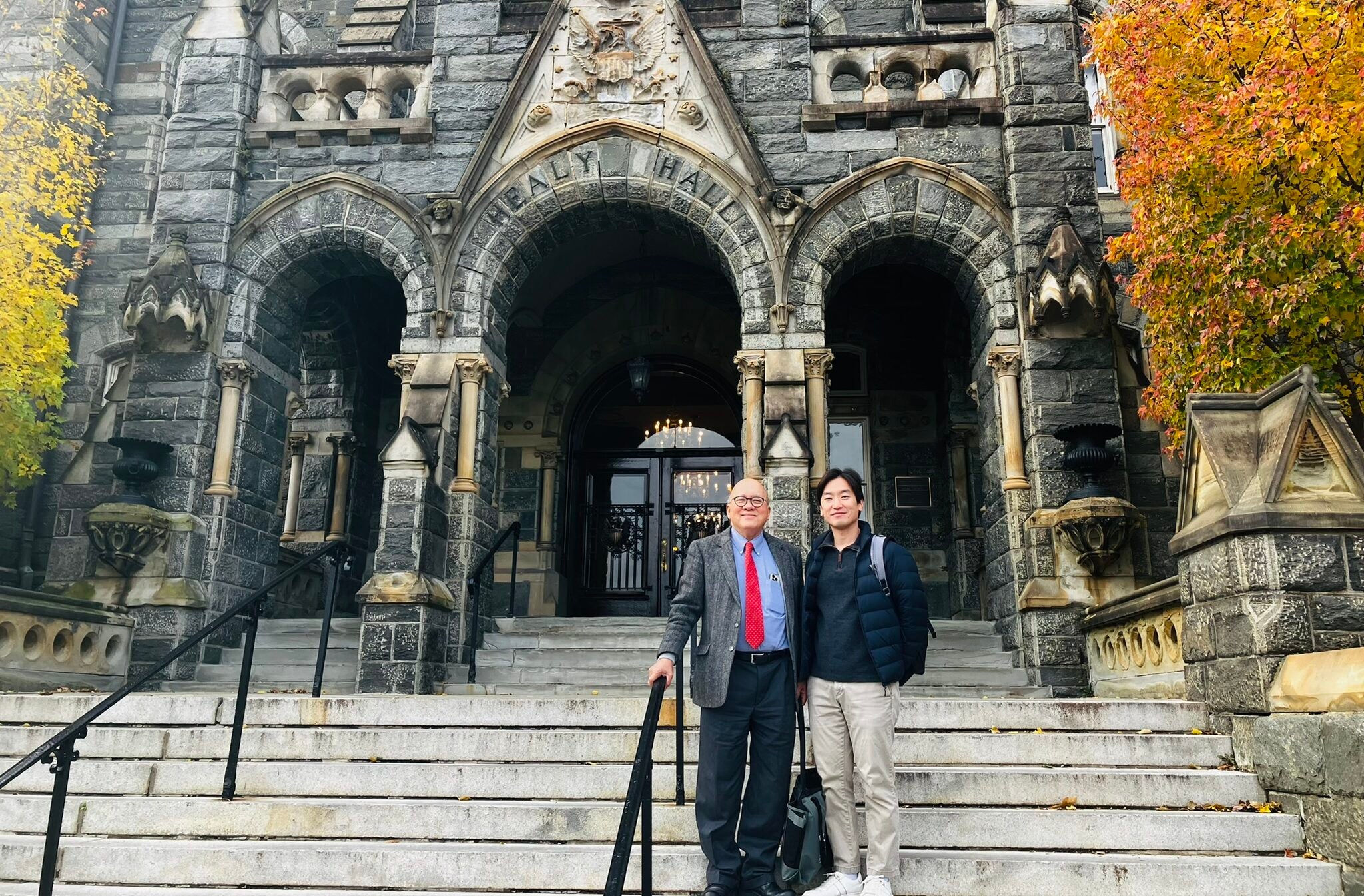 Georgetown student Mideum Hong stands next to his advisor, Professor Peter Phan, left, outside Healy Hall in the fall.