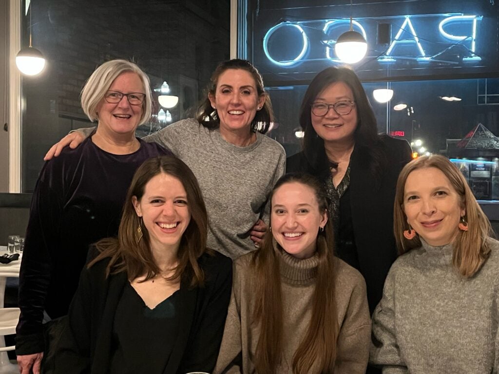 Six women appear in two rows in a group photo.