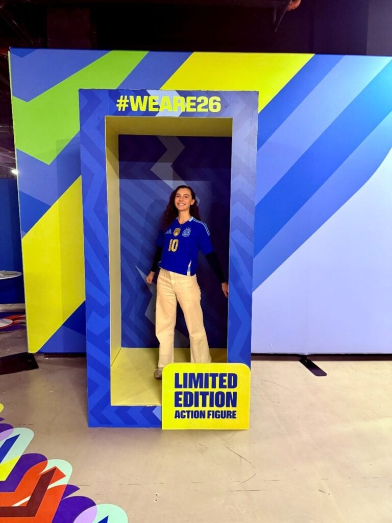 Georgetown Ph.D. student Rachel Beatty takes in a photo op that looks like an action figure box with the text "Limited Edition Action Figure".
